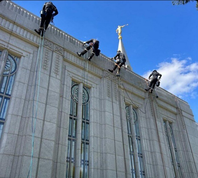 Work on the cornice, next to the angel Moroni